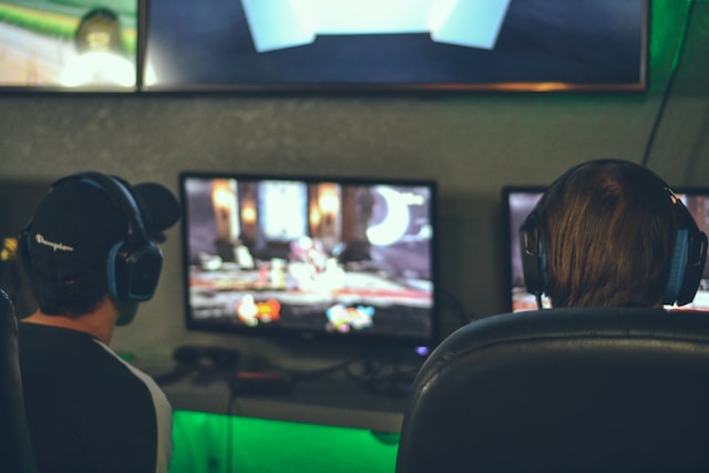 two people in front of screens playing games