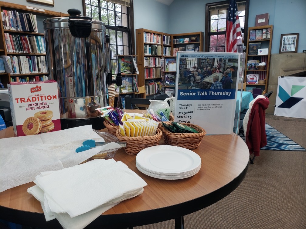 Image of a tea pot and coffee and cookies in the library