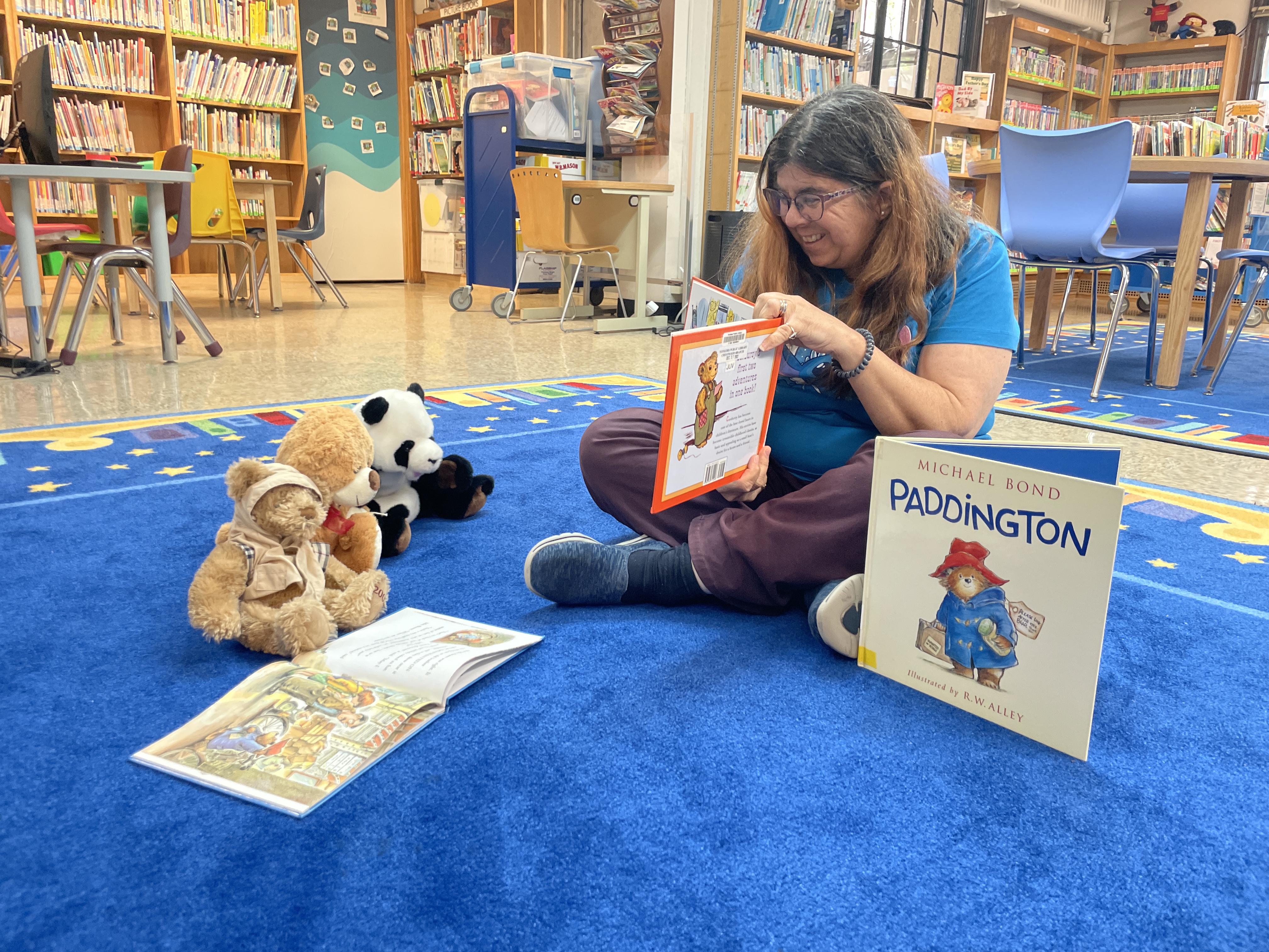 Image of Miss Nancy reading to Teddy Bears