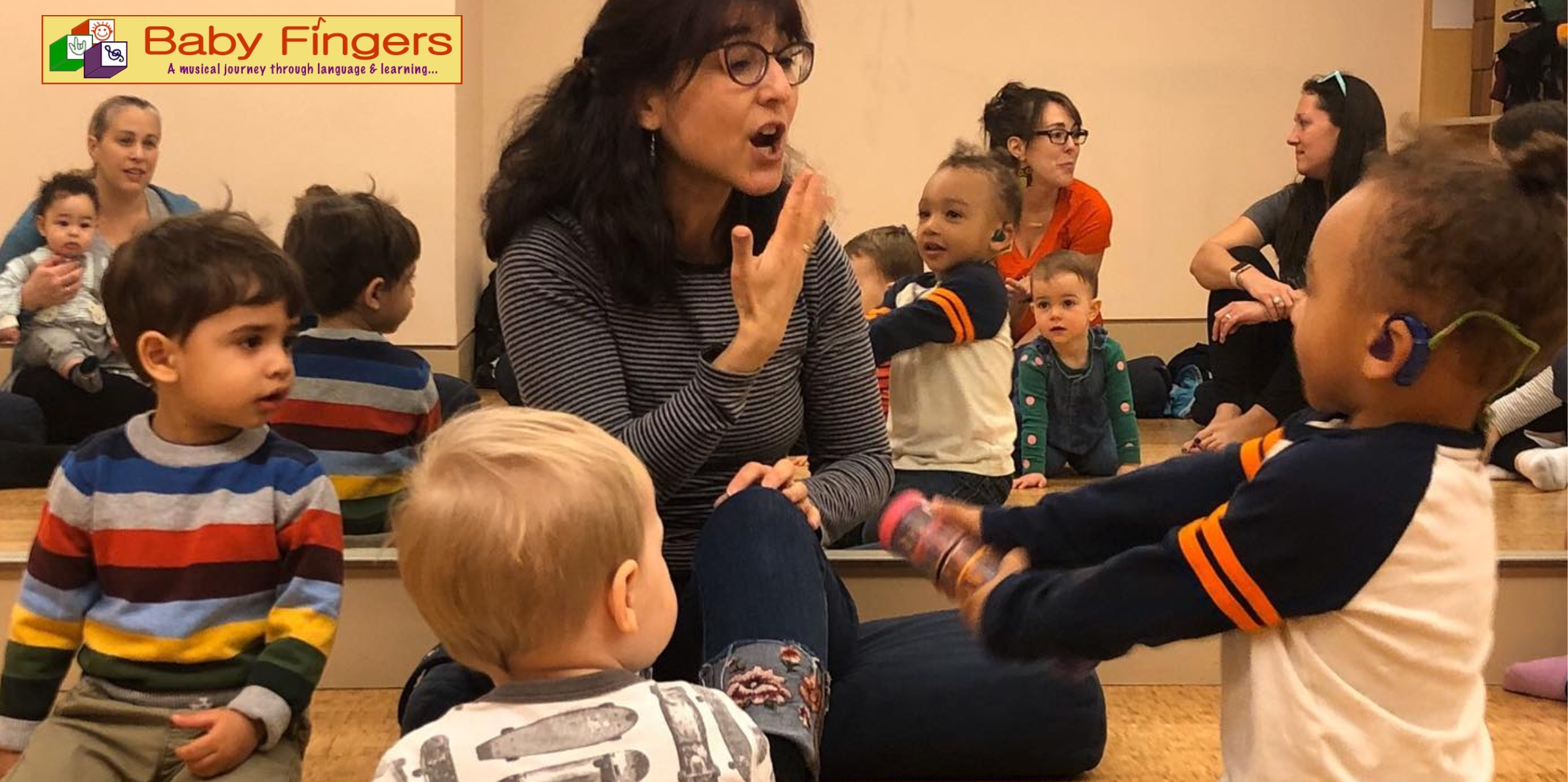 woman signing ASL with young children