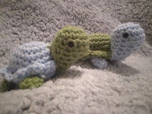 two blue and green crochet turtles