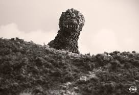Image of Godzilla 1954 looking over a hill