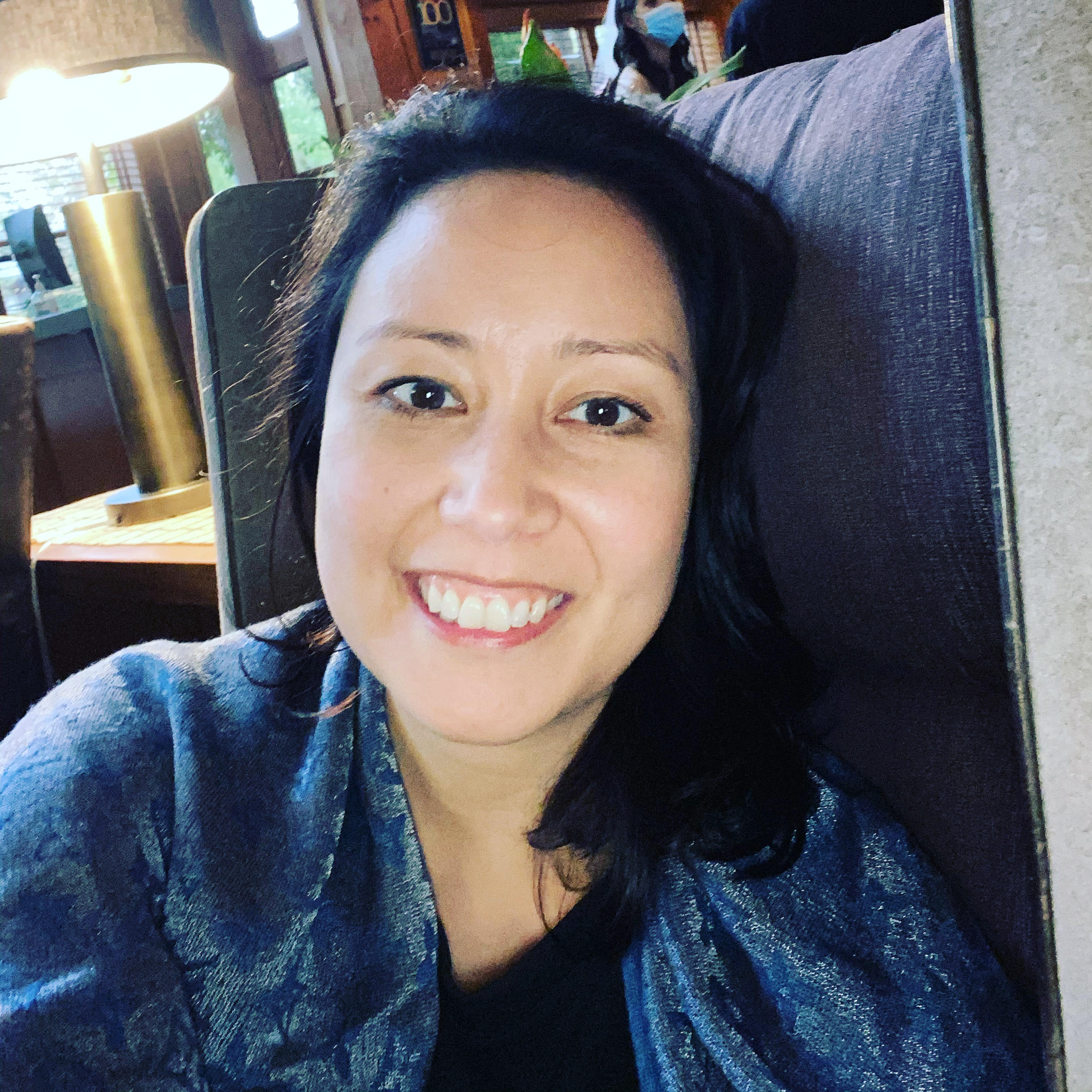 A headshot of Andrea Kartika Deierlein from Thrive Reiki.