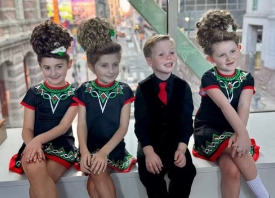 Four children in Irish Dance costumes