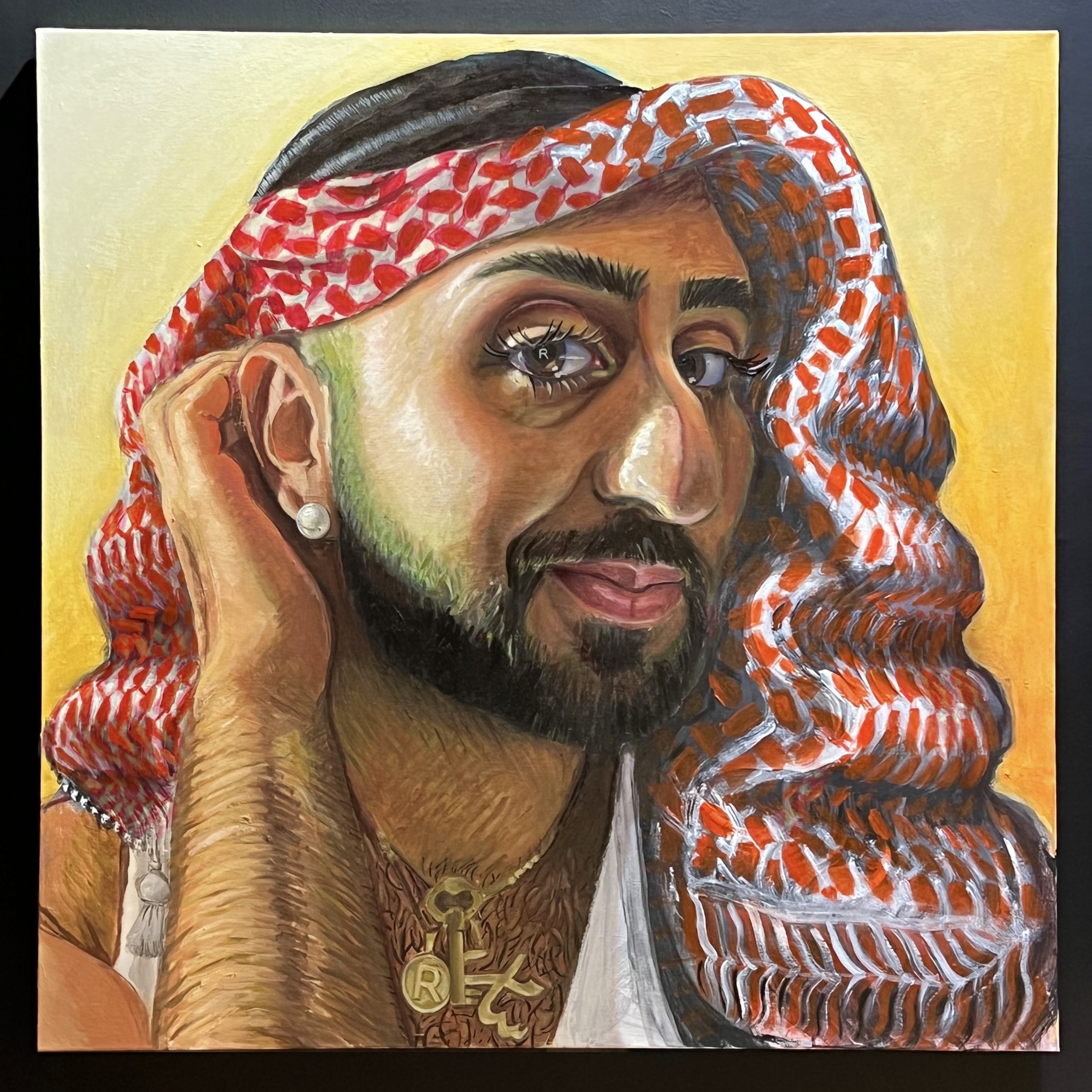 Portrait of artist RIDIKKULUZ tucking a wavy keffiyeh behind their ear as though it were hair