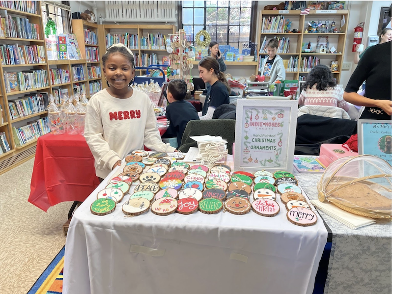 A Holiday Bazaar participant with wooden ornaments.