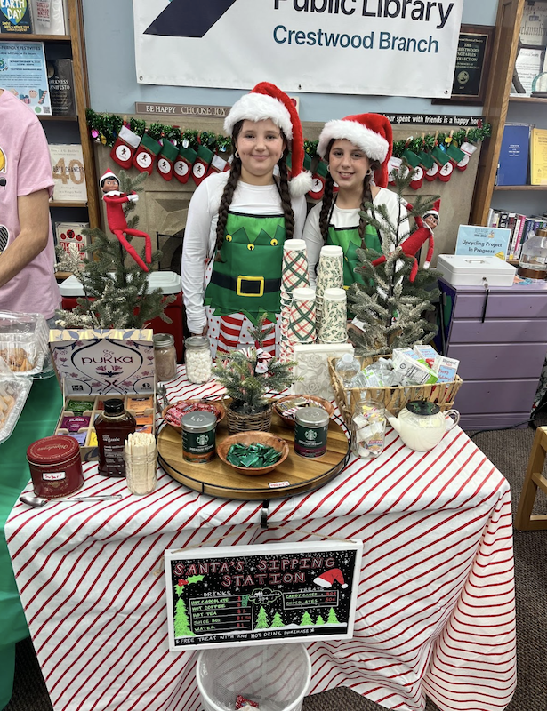 Holiday Bazaar participants with a hot chocolate stand.