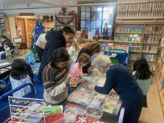 Patrons at the Crestwood Library selecting beads for their earring making.