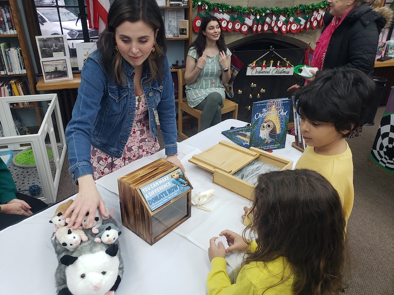 Representatives from Cottontail Cottage educating children on oppossums.