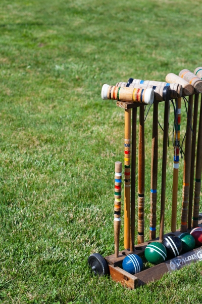 Croquet set on green grass. 