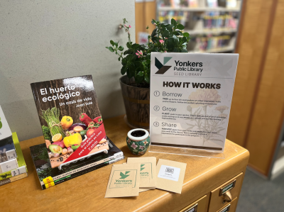 card catalog with gardening books, seed packets, and a sign that rads "YPL Seed Library: How it Works"