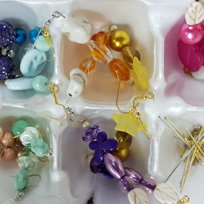 Carton filled with earrings created by Yonkers residents at a Crafts for a Cause program