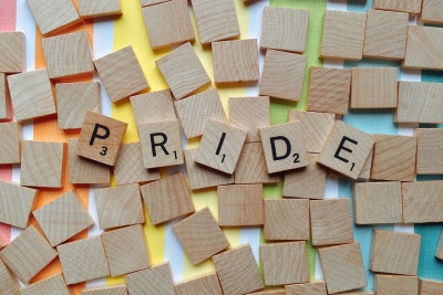 Scrabble letters spelling out the word "pride".