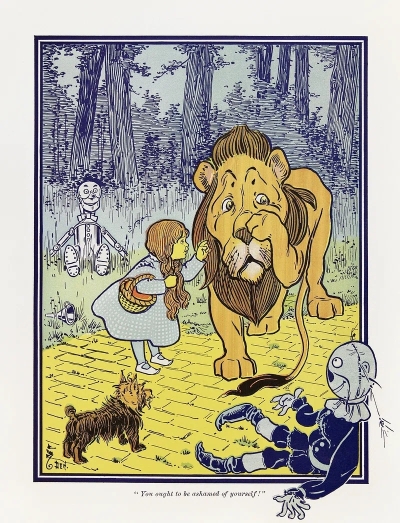 An illustration from "The Wonderful Wizard of Oz". Dorothy is trying to comfort the Cowardly Lion as the Scarecrow, the Tin Man, and her dog Toto watch.