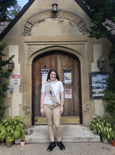 Girl Scount Alana outside of the Crestwood Library.
