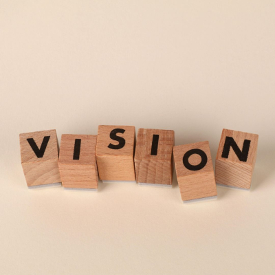 Wooden blocks with letters spelling out the word "vision".