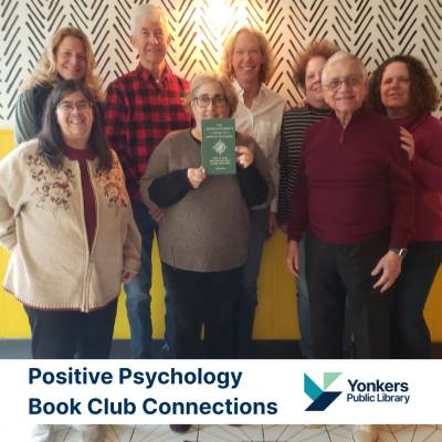 Participants in the Positive Psychology Book Group posing with one of the club reads.