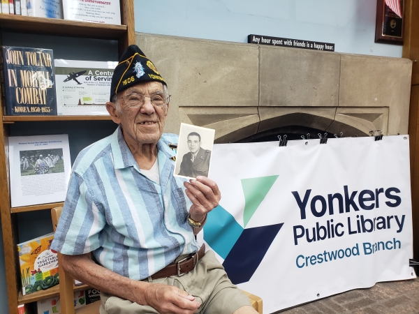 Local veteran Lee poses with his military portrait