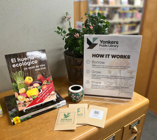 card catalog with gardening books, seed packets, and a sign that rads "YPL Seed Library: How it Works"