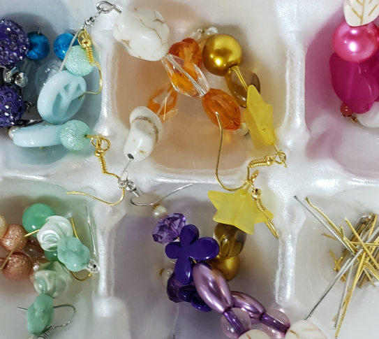 Carton filled with earrings created by Yonkers residents at a Crafts for a Cause program