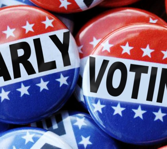 Photograph of campaign buttons reading "Early" and "Voting"