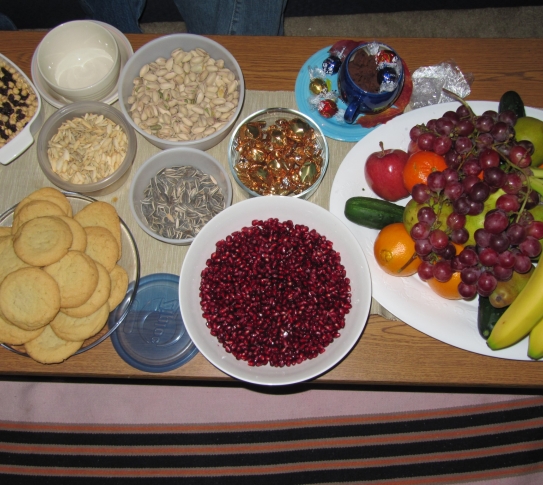 A table with several food dishes laid out to celebrate Yalda Night.