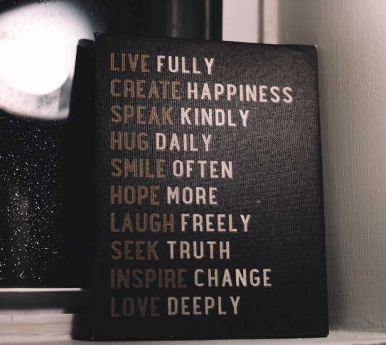 A canvas with the words: live fully, create happiness, speak kindly, hug daily, smile often, hope more, laugh freely, seek truth, inspire change and love deeply.
