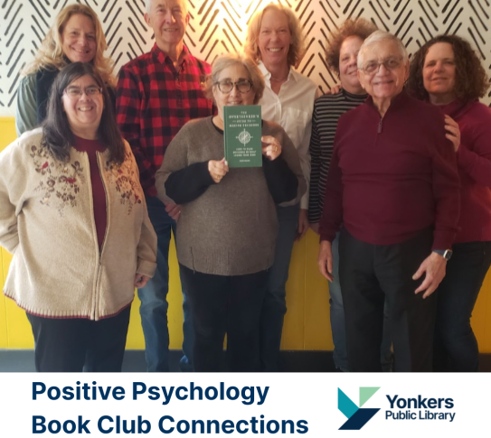 Participants in the Positive Psychology Book Group posing with one of the club reads.