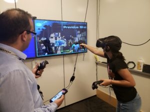 Teen and adult playing virtual reality game.