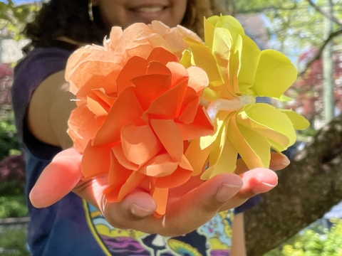 Say holding paper flowers