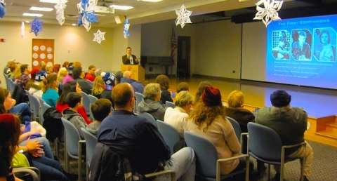 presenter clive young in front of an audience at a public library