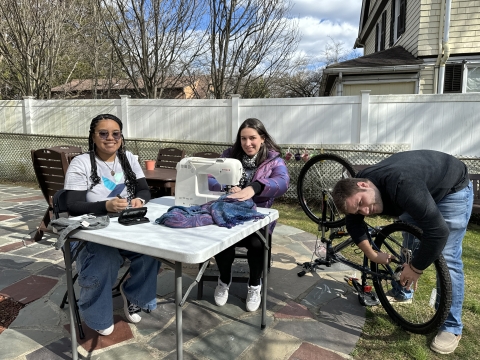Image of repair cafe with staff and bike, Switch & sewing