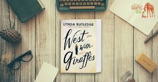 book west with giraffes surrounded by items on a desk