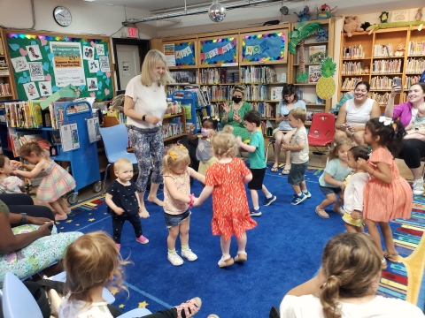Daphne dancing with children in Crestwood Library