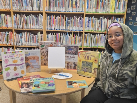 Say surrounded by art books and a plain canvas