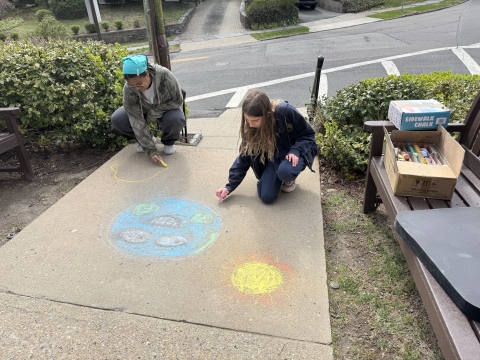 Image of people drawing in chalk