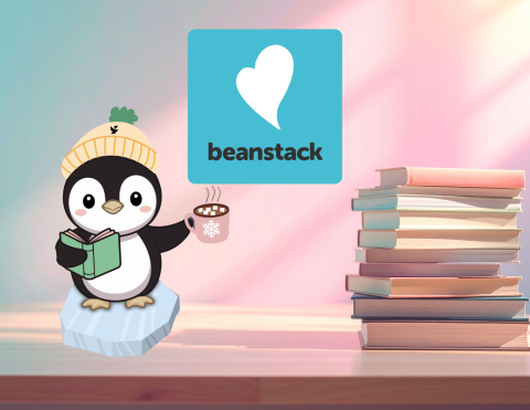 image of penguin holding a mug of hot chocolate with  beanstack logo next to it and a stack of books next to that