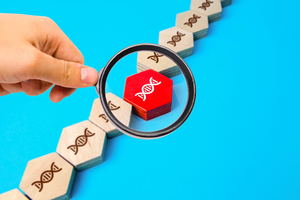 Teal background with a hand picking out red genome (decoding cancer program)