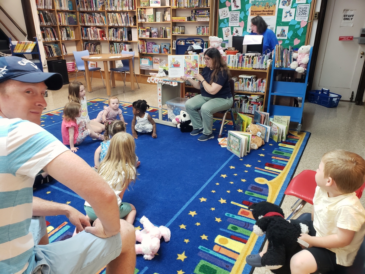 Image of Miss Nancy reading to children