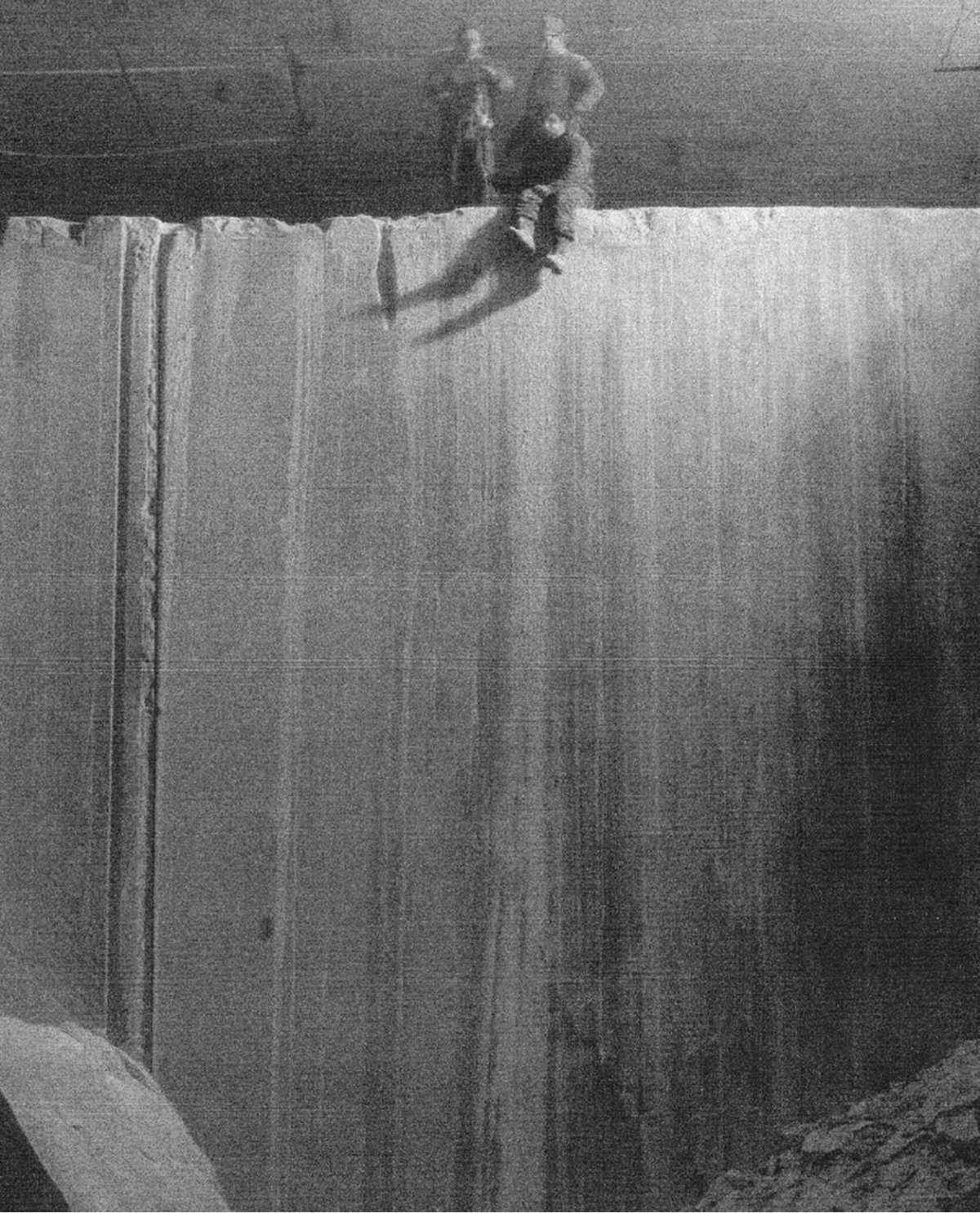 two people sitting on a huge slab of Tuckahoe Marble