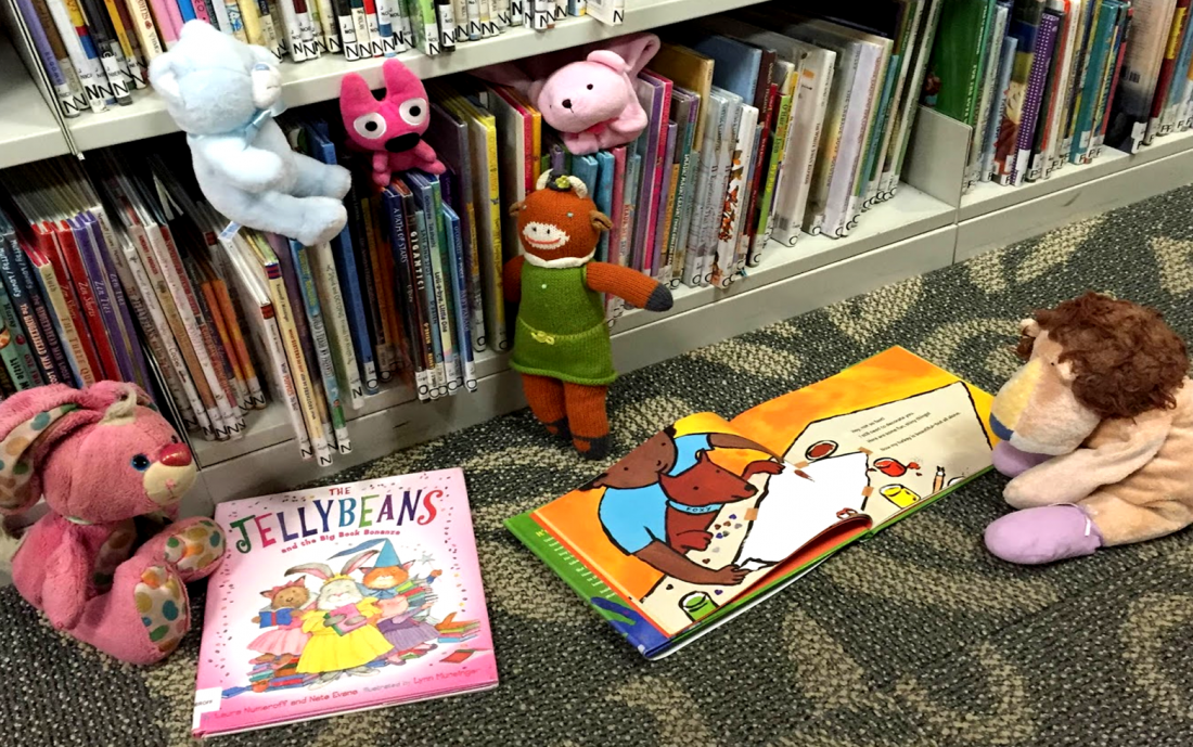 stuffed animals with a bookcase and books