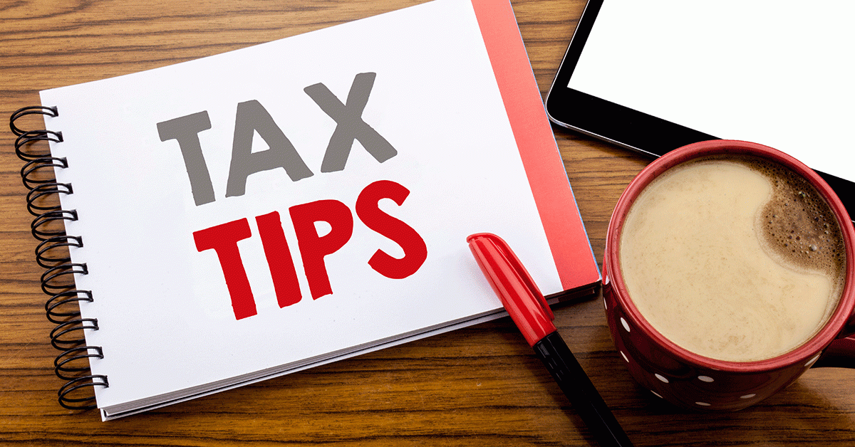 tax tips on a pad of paper with a pen and a cup of coffee