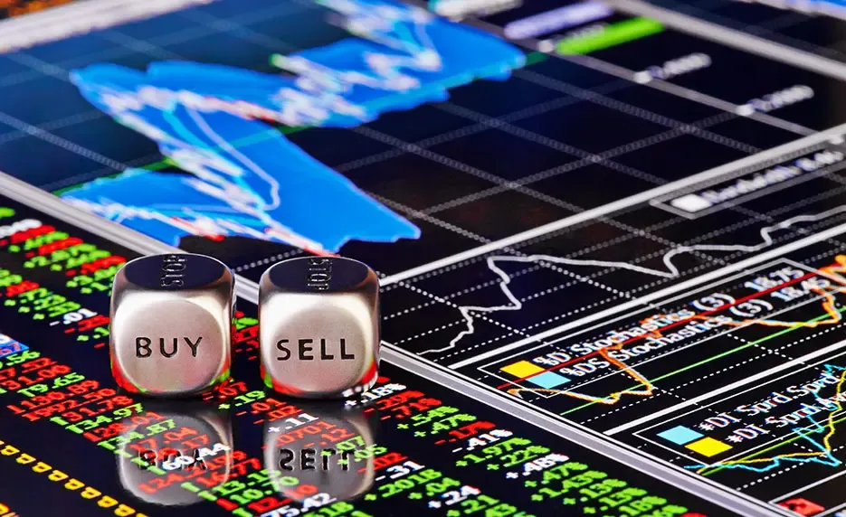 dice with words buy and sell over a stock. market investment chart