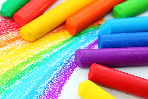 image of rainbow drawing with oil pastels of various colors sitting on top of it