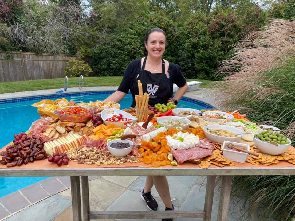 image of Chef Ashley with a cheeseboard