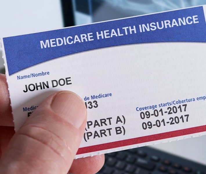 Close up image of hand holding generic medicare card